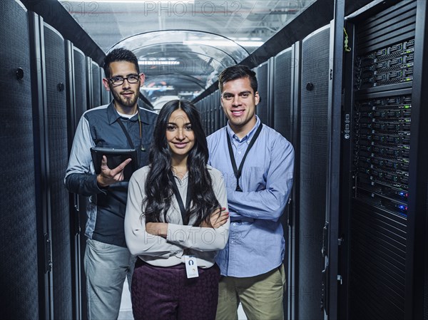 Technicians smiling in server room