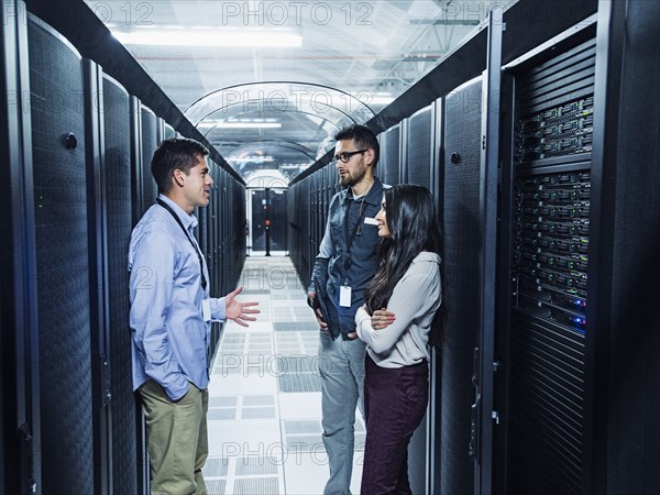 Technicians talking in server room