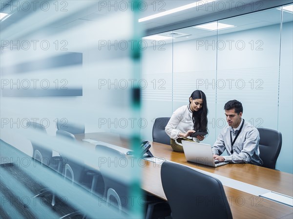 Business people using technology in conference room