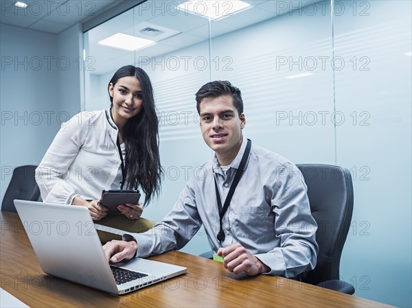 Business people using technology in conference room