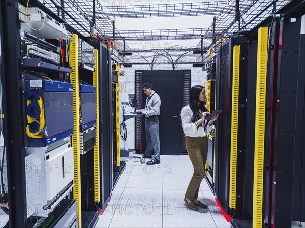 Technicians working in server room