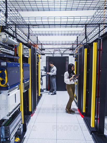 Technicians working in server room