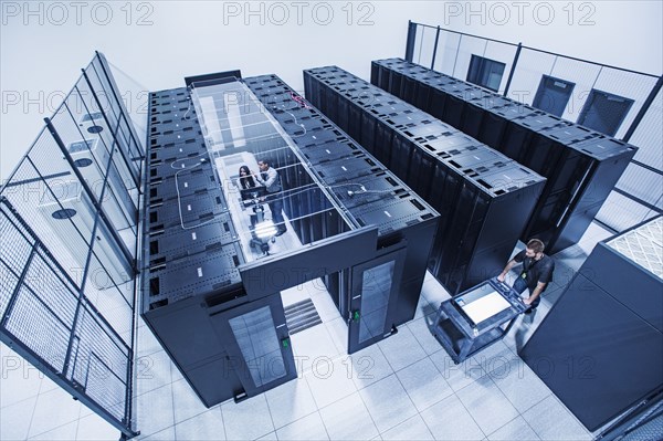 High angle view of technicians working in server room