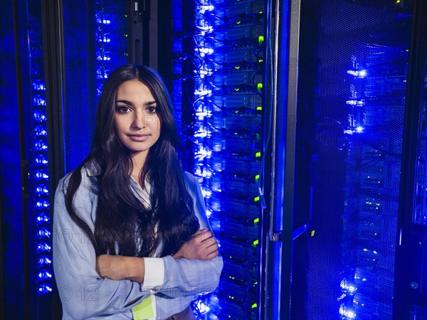 Mixed race technician standing in server room