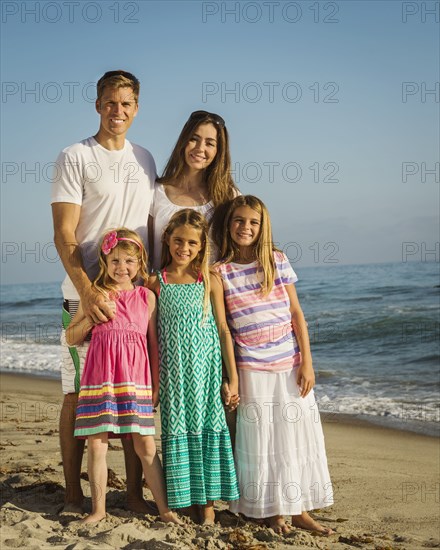 Caucasian family smiling on beach