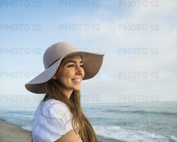 Caucasian woman smiling on beach