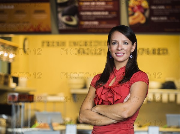 Hispanic woman smiling in cafe