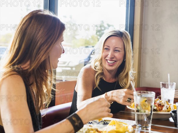 Caucasian women eating in cafe