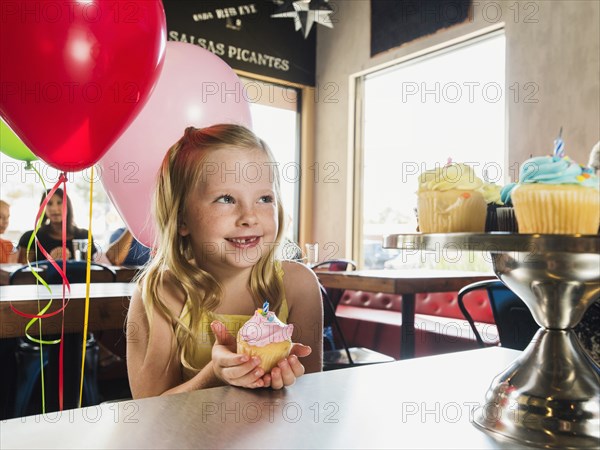 Caucasian girl celebrating birthday in cafe