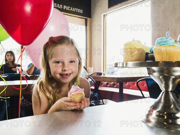 Caucasian girl celebrating birthday in cafe