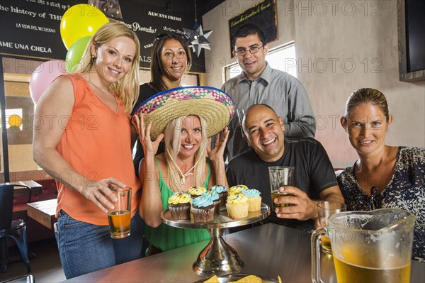 Friends celebrating birthday in cafe