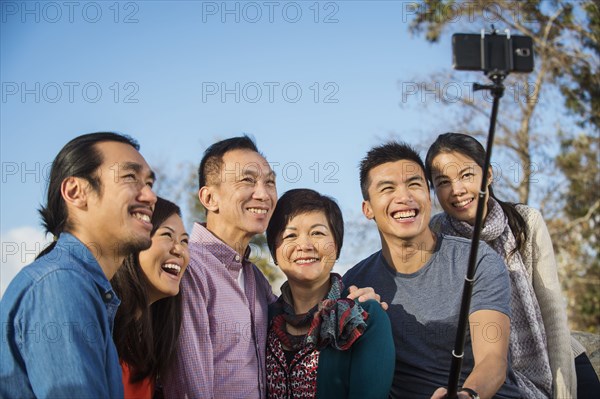 Chinese family taking photograph with selfie stick