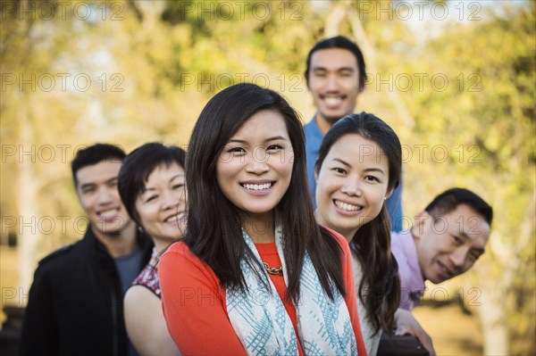 Chinese family smiling outdoors