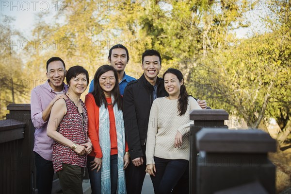 Chinese family smiling outdoors