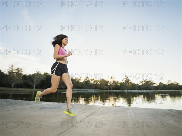 Chinese woman jogging in park