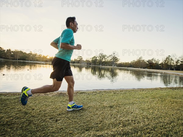 Older Chinese man running in park