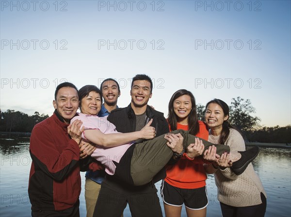 Chinese family posing near lake outdoors