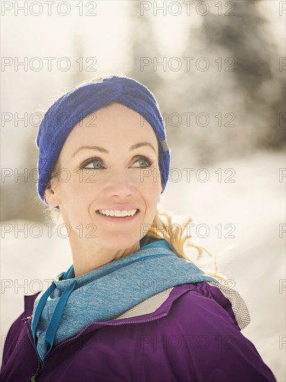 Caucasian woman smiling in snow