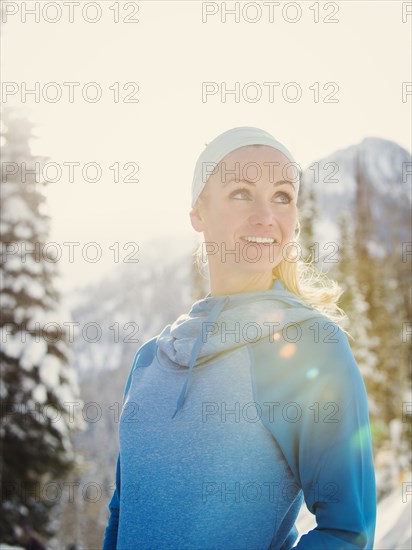 Caucasian woman smiling in snow