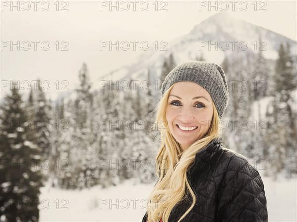 Caucasian woman smiling in snow