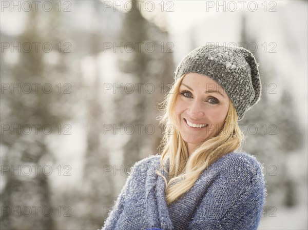 Caucasian woman smiling in snow