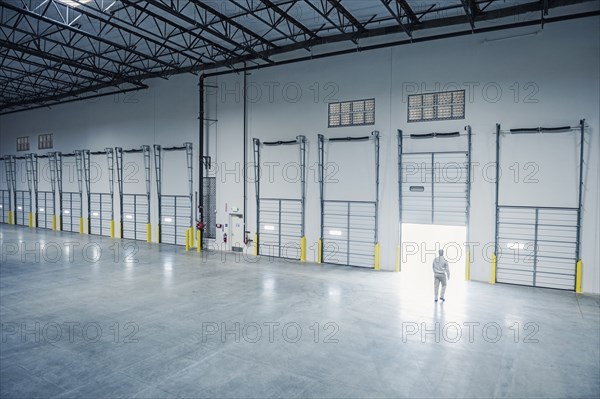 Caucasian businessman walking near open door on loading dock