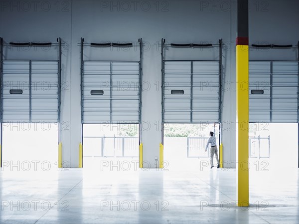 Caucasian businessman lifting loading dock door