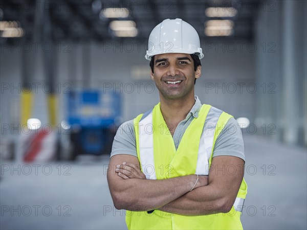 Smiling indian worker in warehouse