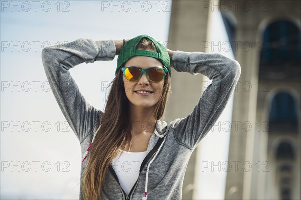 Smiling Caucasian woman posing under overpass