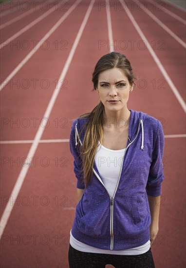 Caucasian woman posing on running track