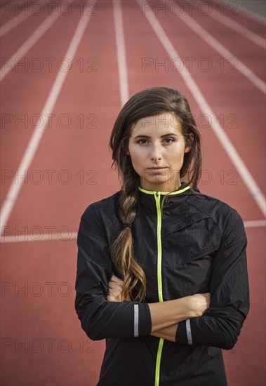 Caucasian woman posing on running track