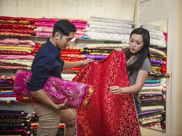 Chinese man and woman shopping for fabric
