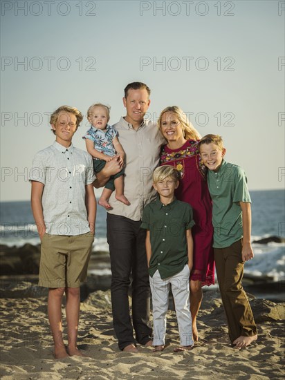 Caucasian family posing on beach