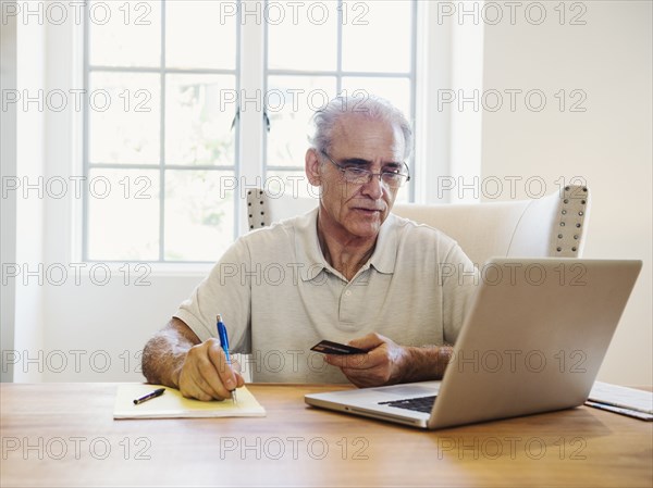 Caucasian man online shopping on laptop