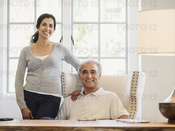 Portrait of couple posing near window