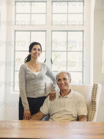 Portrait of couple posing near window