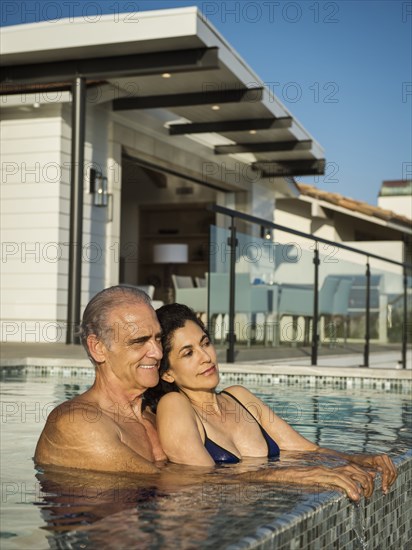 Older couple relaxing in swimming pool