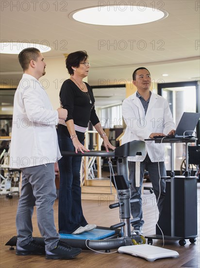 Physical therapists examining patient