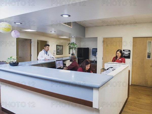 Doctor and nurses at counter in hospital