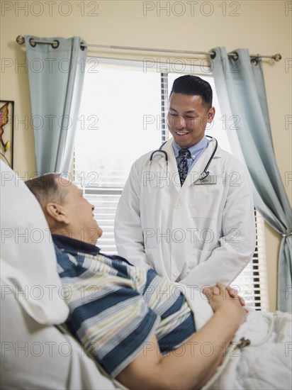 Doctor talking to patient in hospital bed