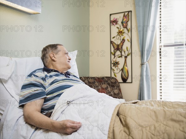 Caucasian man laying in bed