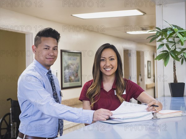 Smiling doctor and nurse in hospital