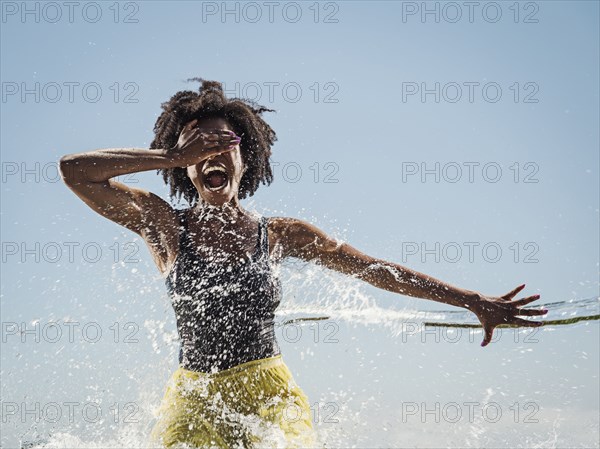 Water spraying on black woman dancing