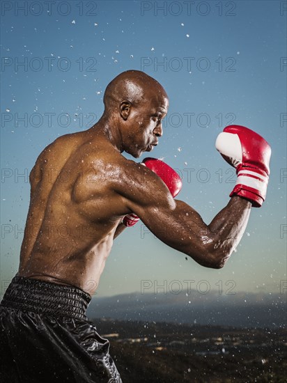 Water splashing on black boxer outdoors