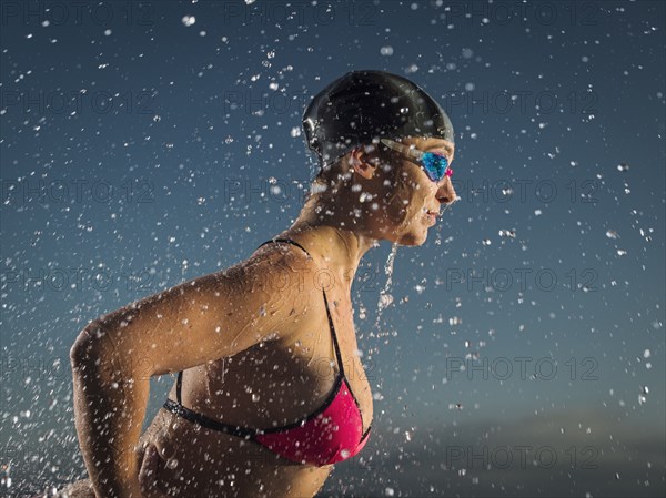 Water splashing on Caucasian swimmer