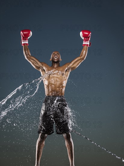 Water splashing on winning Black boxer