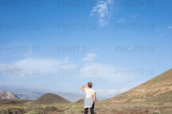 Caucasian woman admiring scenic view of distant landscape