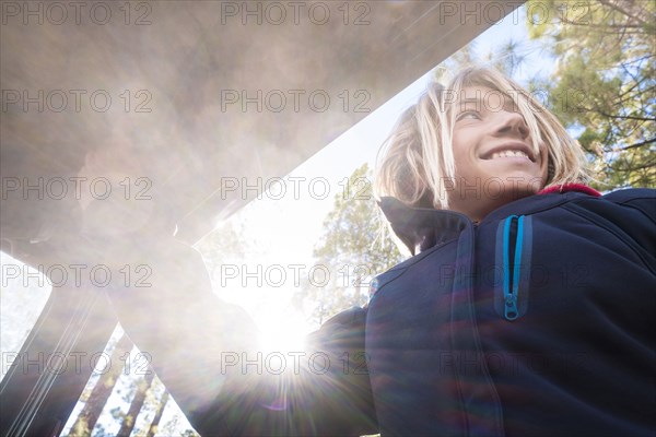 Portrait of Caucasian boy in car window