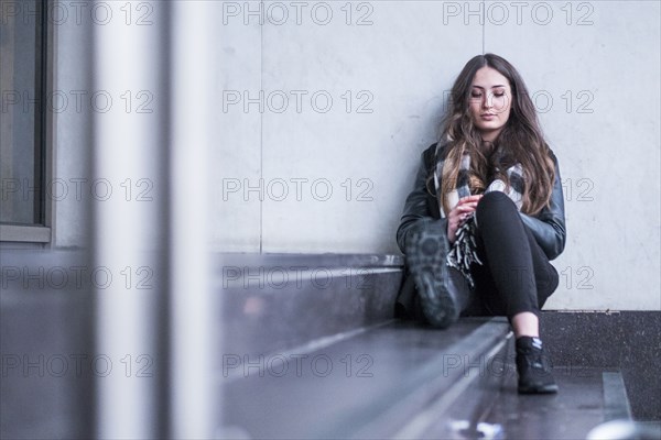 Pensive Caucasian woman sitting on staircase