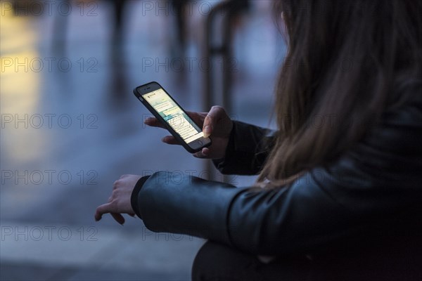 Caucasian woman texting on cell phone outdoors